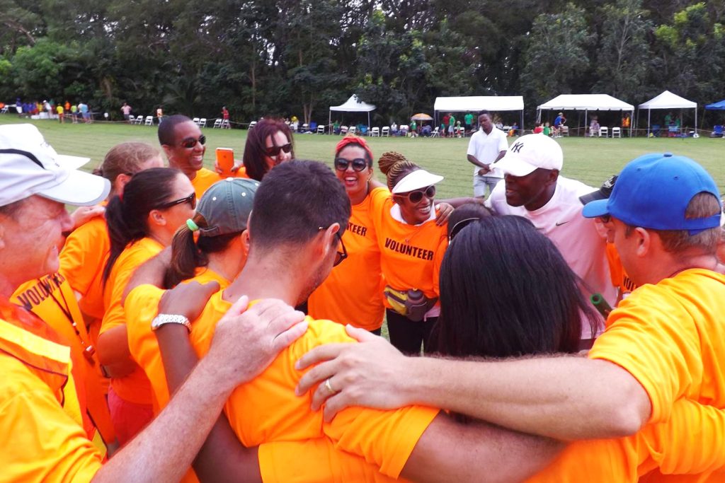 Parents and community - volunteer group in huddle