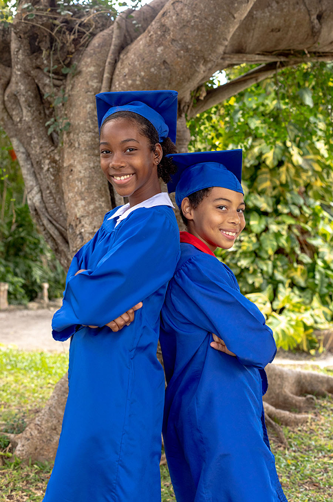 Graduates standing back to back outside