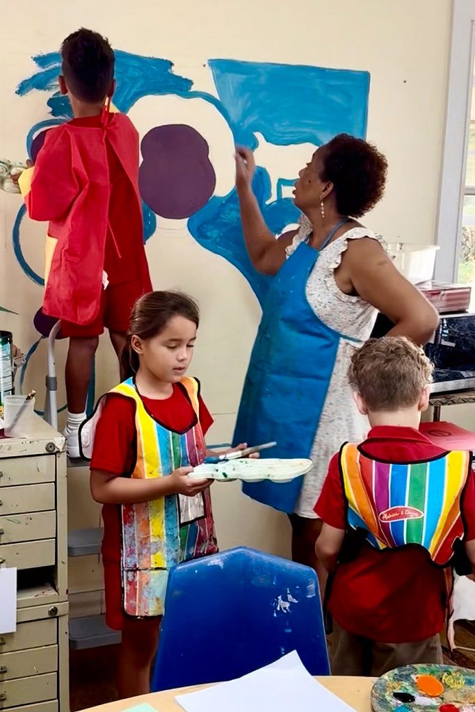 Teacher-and-pupil-painting-a-mural