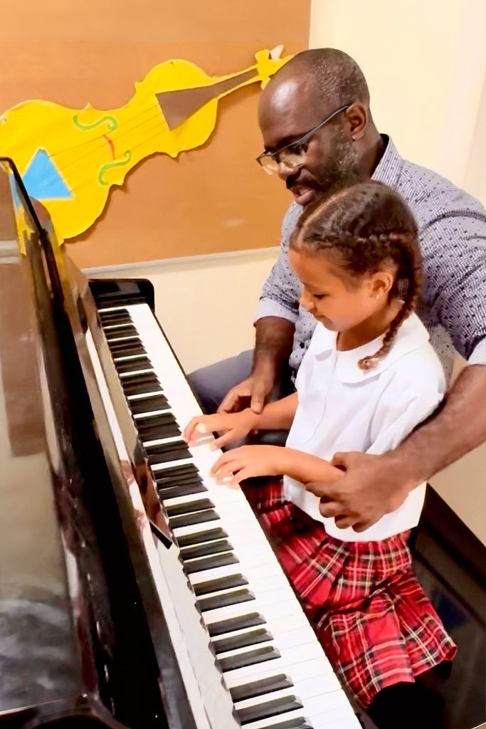 Teacher-and-pupil-playing-piano