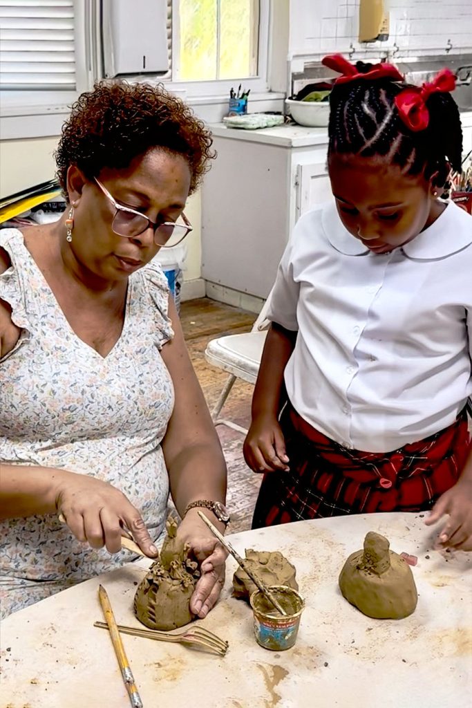 Teacher-and-student-working-with-clay